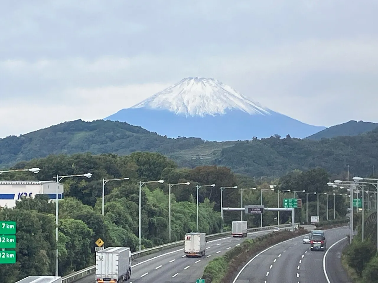 The Tomei Expressway with snow-capped Mount Fuji behind it
